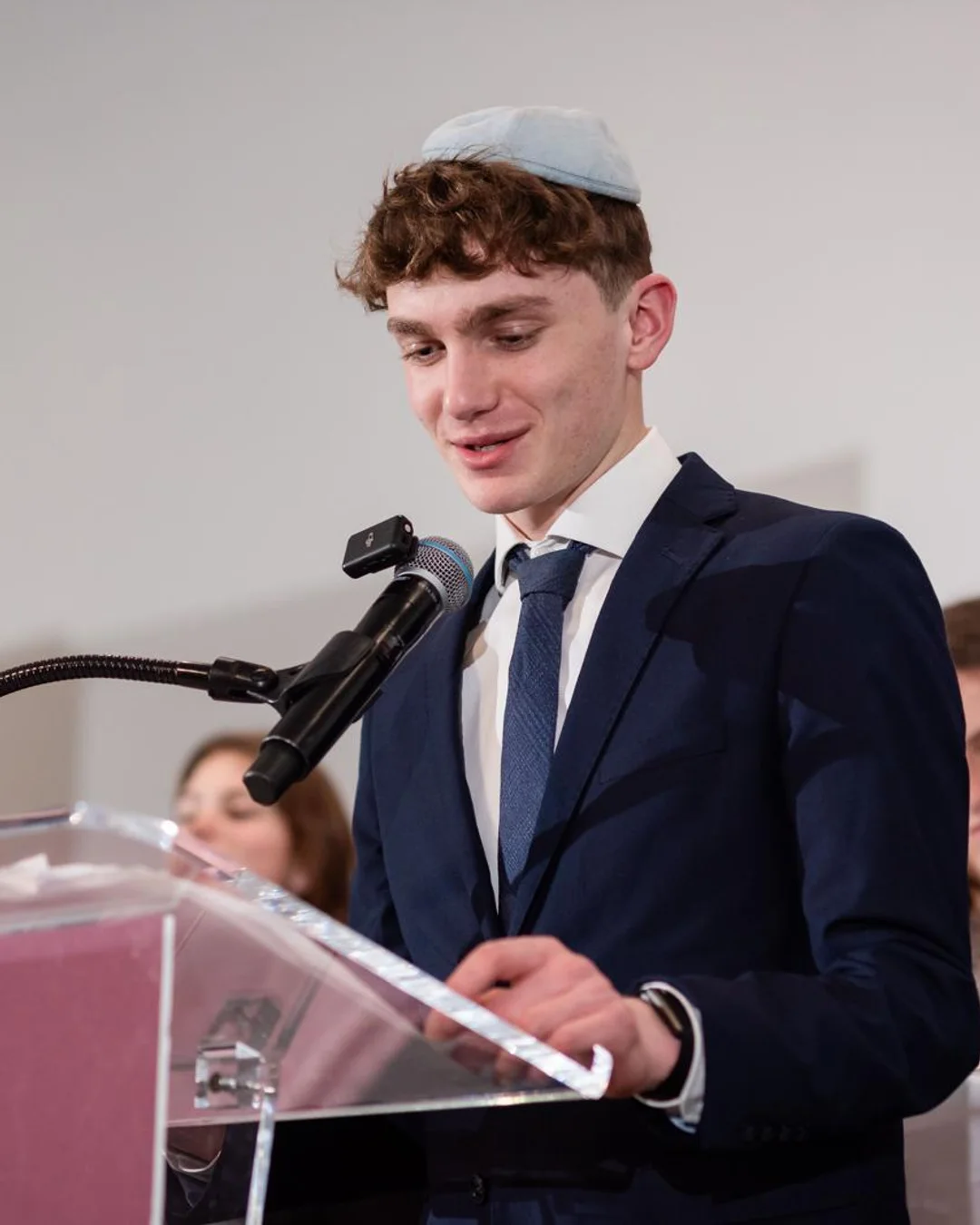 Efraim Dechter speaking at a podium
